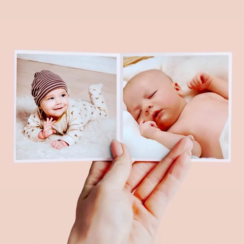 klikkie pocket photo books in lay-flat format, stacked on a wooden table